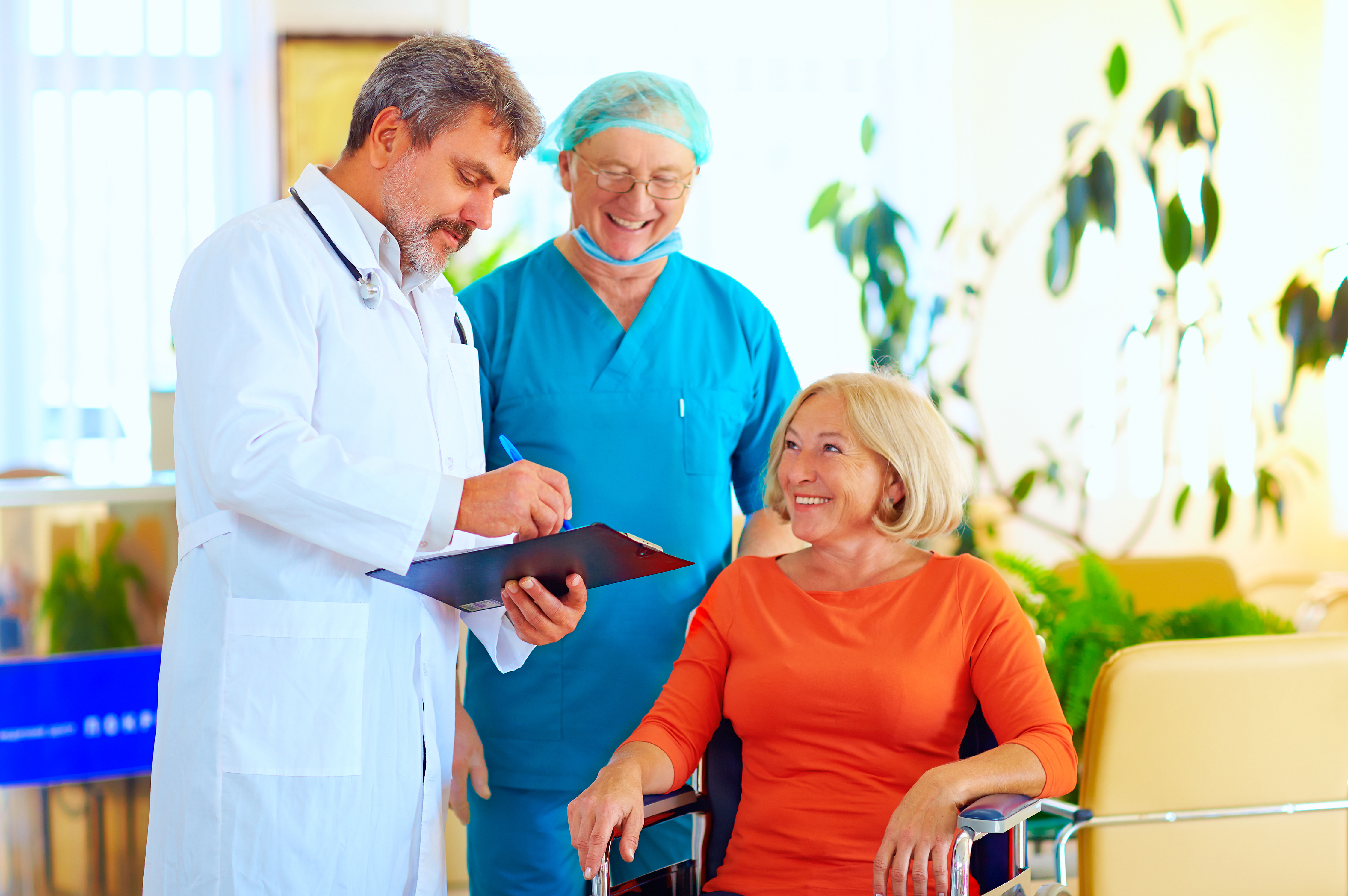 Woman being discharged from a hospital as her doctor gives her instructions